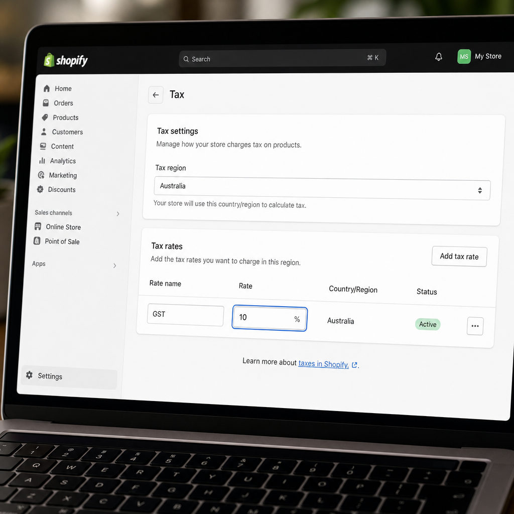 Close-up of a laptop screen showing Shopify admin tax settings panel with Australia selected and a 10% tax rate field highlighted, clean modern UI, photorealistic